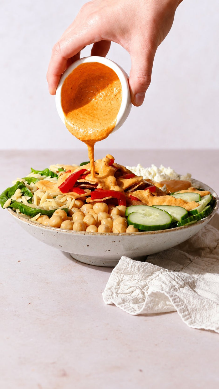 Fresh avocado oil dressing poured over a crisp salad